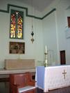 Interior alternate view of altar and stained glass window