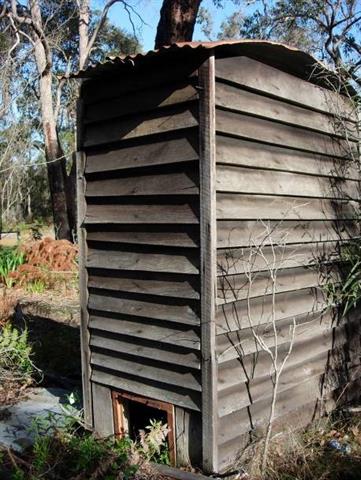 Old jarrah toilet with curved roof